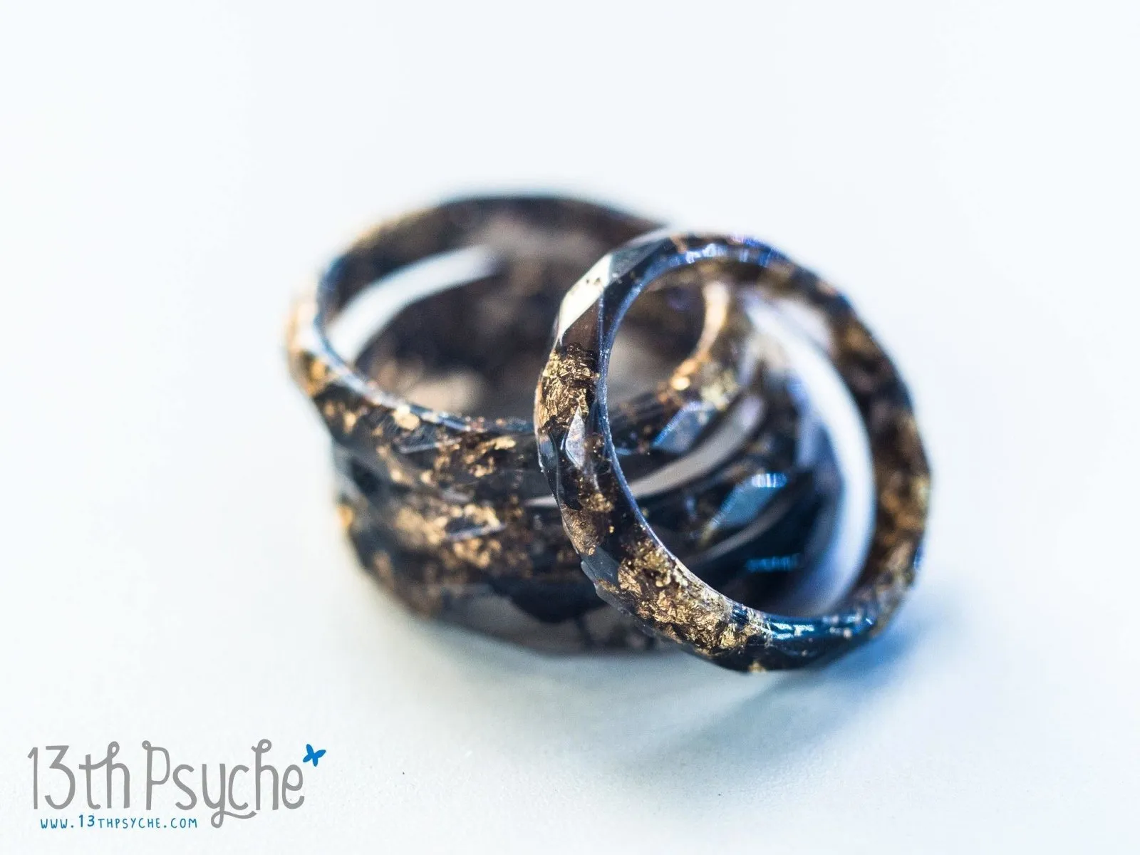 Black faceted resin ring with gold flakes