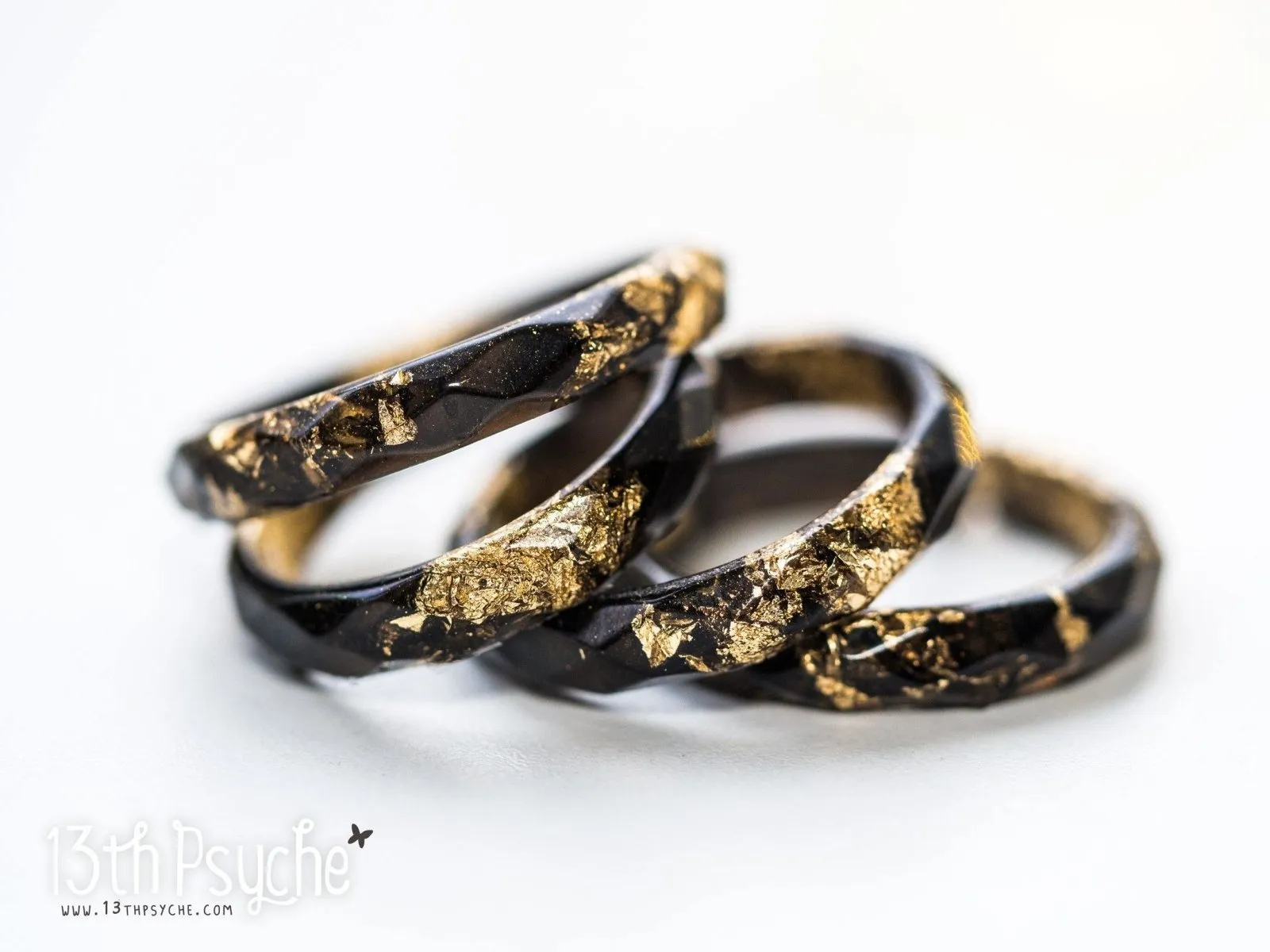 Black faceted resin ring with gold flakes